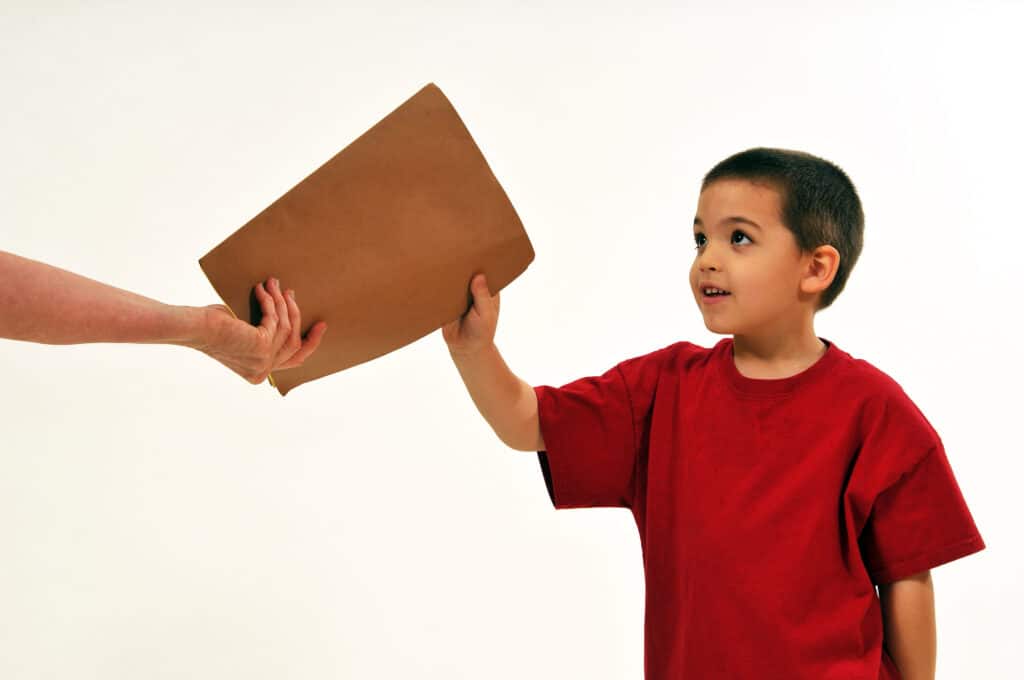 teacher sending student on errand to deliver folder